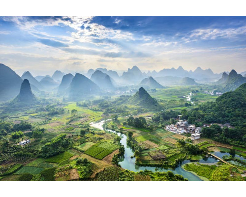 Fototapete der Karstberge im Dorf Yangshuo, China, mit Bergen, die sich über eine malerische Landschaft erheben.