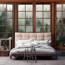 Eine Fototapete mit 3D-Fensterblick auf einen nebligen Wald im Vliesbehangstil für ein Schlafzimmer.