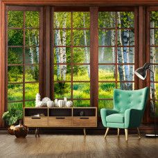 Eine Fototapete mit 3D-Fensterblick auf einen Birkenwald in einem warmen Wohnzimmer.