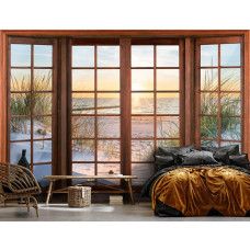 Eine Fototapete mit 3D-Fensteransicht der Dünen, des Strandes und des Meeres bei Sonnenuntergang in einem ruhigen Schlafzimmer.