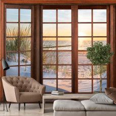 Eine Fototapete mit 3D-Fensteransicht der Dünen, des Strandes und des Meeres bei Sonnenuntergang in einem stilvollen Wohnzimmer.