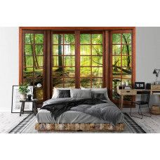 Eine Fototapete mit 3D-Fensteransicht einer sonnigen Waldlandschaft im Vliestapetenstil für ein Schlafzimmer.
