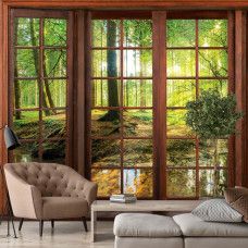 Eine Fototapete mit 3D-Fensteransicht einer sonnigen Waldlandschaft im Vliestapetenstil für ein Wohnzimmer.