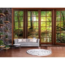 Eine Fototapete mit 3D-Fensteransicht einer sonnigen Waldlandschaft in einem modernen Wohnzimmer.