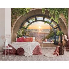 Eine Fototapete mit einem Sonnenuntergang über dem Meer und Dünen, geeignet für ein Schlafzimmer.