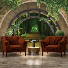 Eine Fototapete mit einem idyllischen Weg durch den Wald, geeignet für ein Büro.