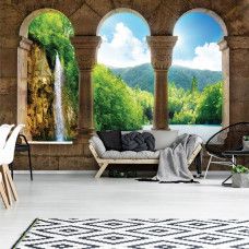 Eine Fototapete mit 3D-Blick auf eine Wasserfall-Landschaft, perfekt für ein Wohnzimmer.