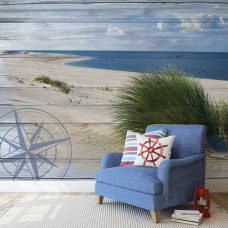 Eine Fototapete mit einer beruhigenden Strandlandschaft mit Dünen und Meer in einem Schlafzimmer.