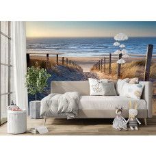 Fototapete mit einem Sandweg durch die Dünen in einem modern eingerichteten Wohnzimmer mit viel Tageslicht.