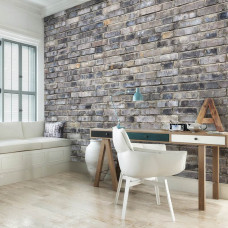 Eine Fototapete einer grauen Steinwand im Industriestil in einem Büro.