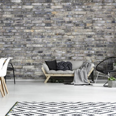 Eine Fototapete einer grauen Steinwand im Industriestil im Wohnzimmer.