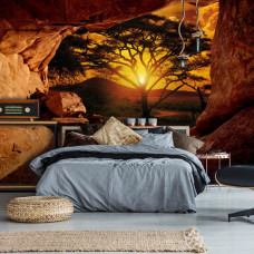 Eine Fototapete von einer Höhle mit Blick auf einen Sonnenuntergang für das Schlafzimmer.