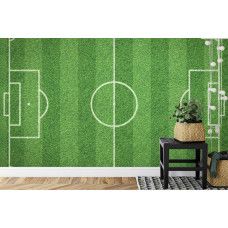 Eine Fototapete mit einem ausgestreckten Grasfeld und einem Fußball in einem Kinderzimmer.