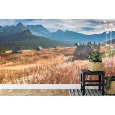 Eine Fototapete mit beeindruckenden Bergen und einem blauen Himmel, ideal für ein Büro.