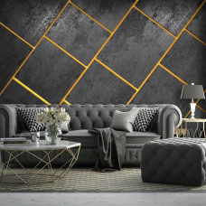 Eine Fototapete mit modernen Fliesen in Schwarz mit goldenen Fugen und Grautönen in einem industriellen Wohnzimmer.