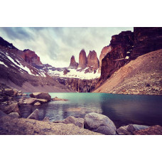Fototapete des Torres del Paine Nationalparks in Chile, mit Bergen, die sich hoch über eine zerklüftete Naturlandschaft erheben.