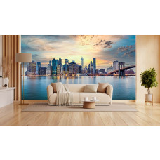 Fototapete New York Skyline bei Sonnenuntergang Panorama im Wohnzimmer mit warmer Abendstimmung und Spiegelung im Wasser.
