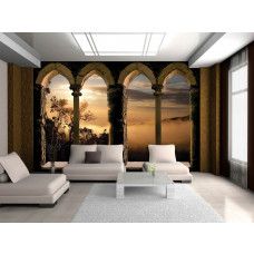 Eine Fototapete, die einen Blick durch römische Fenster mit Säulen und eine beeindruckende Landschaft gibt.