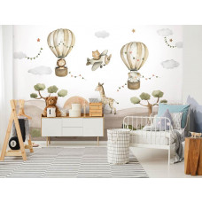 Löwe und Elefant in einem Heißluftballon zwischen Wolken und Luftschlangen, mit Zebra, Affe und Giraffe in der Savanne bei Sonnenuntergang.