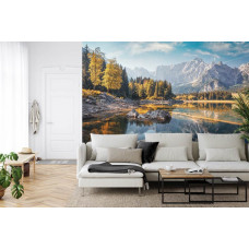 Eine Fototapete mit einem ruhigen Waldsee und Bergen, abgebildet in einem Wohnzimmer.