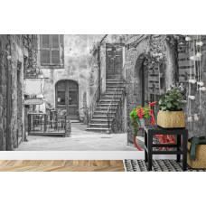 Eine Fototapete mit einer farbenfrohen Straße in Pienza, Toskana, Italien, dargestellt in einer lebendigen Umgebung.