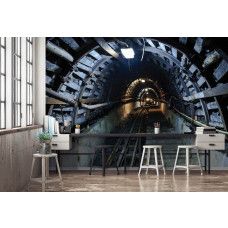 Eine Fototapete mit einem Minengleis in einer Höhle, ideal für ein Wohnzimmer oder Schlafzimmer.