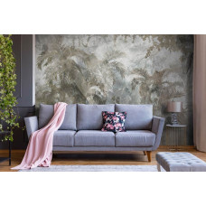 Eine Fototapete mit tropischer Wildnis und Dschungelpflanzen vor einem Betonhintergrund im Wohnzimmer.