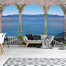 Eine Fototapete mit Meerblick von einem griechischen Balkon mit Säulen.
