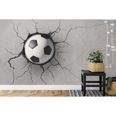 Eine Fototapete mit einem beeindruckenden 3D-Design eines Fußballs, der in eine Wand in einem Kinderzimmer eingebettet ist.
