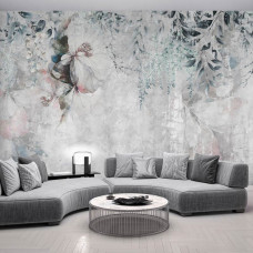 Ein Fototapet von üppigen Blumen und Pflanzen auf einer Betonstruktur in einem Wohnzimmer.