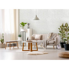 Eine Fototapete mit einer weißen Ziegelwand für einen industriellen Look im Wohnzimmer.