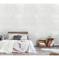 Eine weiße Ziegelwand als Fototapete für das Schlafzimmer.