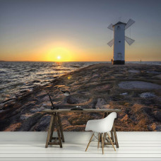 Eine Fototapete von Meer, Strand und einem Leuchtturm bei Sonnenuntergang, ideal für eine Küche.