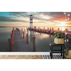 Eine Fototapete mit einem atemberaubenden Blick auf einen Leuchtturm während eines Sonnenuntergangs.