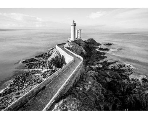 Fototapete mit einem Leuchtturm am Meer, malerische Landschaft Bild.