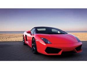 Fototapete von einem roten Lamborghini am Meer, Sportwagen in einer exotischen Landschaft.